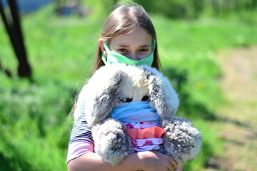 Protection from the flu. Allergy. A little girl in a mask during the pandemic virus.