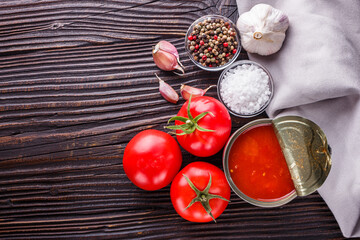 juicy canned tomatoes on wooden rustic background