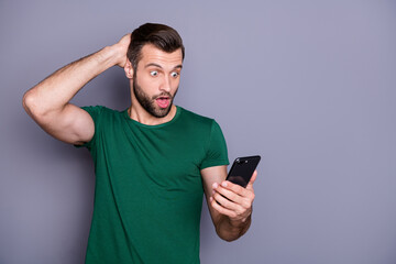 Crazy astonished guy use smartphone search corona virus social media information impressed share post scream omg touch head hand wear good look clothes isolated gray color background