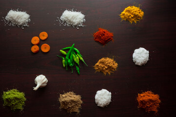 Food ingredients in tabletop with nice colour and spicy, chilley, spoon, prawns, tasty, carrot, ginger, curry leaves, lemon, garlic, sugar.