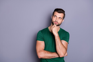 Photo of attractive handsome bearded guy hold arm in chin look up empty space wondered intelligent...