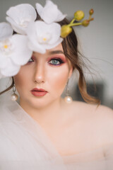 Beautiful model girl bride with bright makeup looks at the camera. Portrait