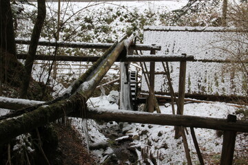 Old water mill, snow, ice, nobody. Abandoned.