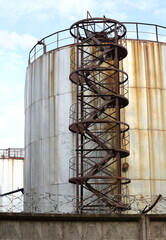 Heat station evaporator with a metal ladder behind a concrete fence