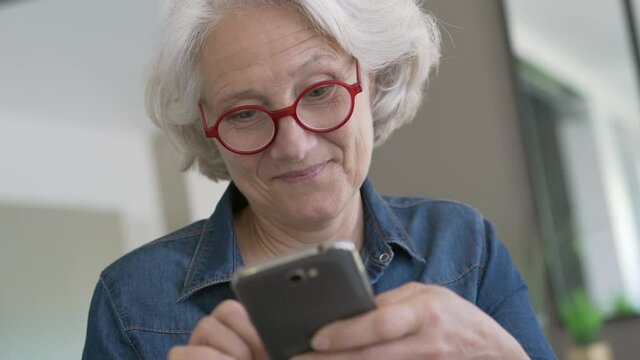Portrait of senior woman using smartphone