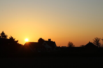 Fototapeta na wymiar House silhouetted in the sunrise