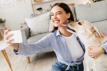 Young woman with her dog taking selfportrait