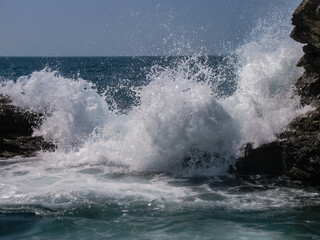 Scenic landscape with wave breaking on the shore