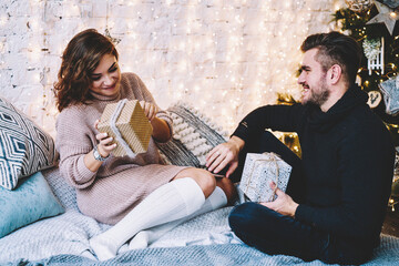 Naklejka premium Happy caucasian couple in love having fun together near beautiful Christmas tree 