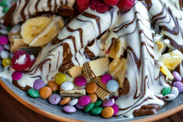 Sweet Waffles with milk chocolate, white chocolate, vanilla cream, strawberries, banana, vanilla ice cream sweet popcorn