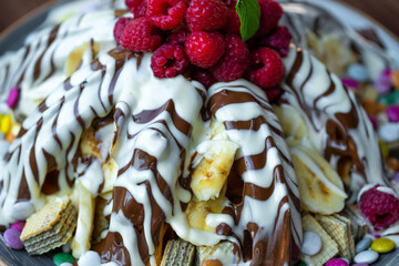 Sweet Waffles with milk chocolate, white chocolate, vanilla cream, strawberries, banana, vanilla ice cream sweet popcorn