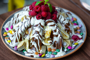 Sweet Waffles with milk chocolate, white chocolate, vanilla cream, strawberries, banana, vanilla ice cream sweet popcorn