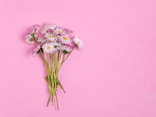 A bouquet of pink flowers on a light pink background. Beautiful background, holiday. Flat bed, top view.