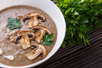 mushroom cream soup on rustic wooden background