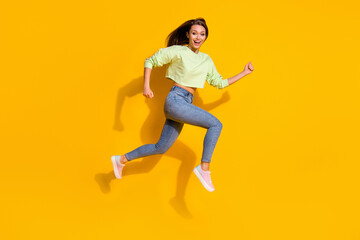Fototapeta na wymiar Full body profile side photo of cheerful enthusiastic girl jump run after season discount wear good look clothes gumshoes isolated over bright color background