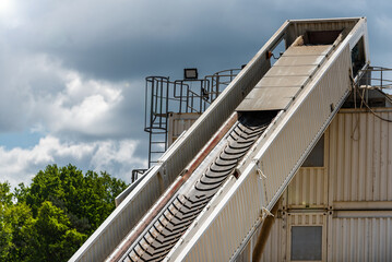 belt conveyor - transport of raw material on the production line - sand, aggregate - view of the mine