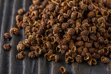 Sichuan pepper on a dark wooden rustic background