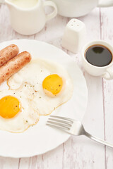 Healthly food. Continental breakfast in hotel room or bed. Fried eggs with sausages. Cup of coffee. Menu template. Cookery. Cooking. Romantic french or rural breakfast on Valentine.