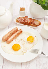 Healthly food. Continental breakfast in hotel room or bed. Fried eggs with sausages. Cup of coffee. Menu template. Cookery. Cooking. Romantic french or rural breakfast on Valentine.