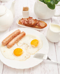 Healthly food. Continental breakfast in hotel room or bed. Fried eggs with sausages. Cup of coffee. Menu template. Cookery. Cooking. Romantic french or rural breakfast on Valentine.