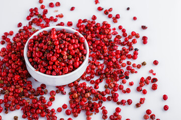 fragrant pink peppercorns on white acrylic background