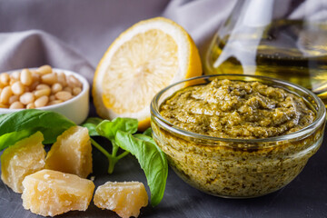 Delicious traditional italian pesto sauce on dark stone background