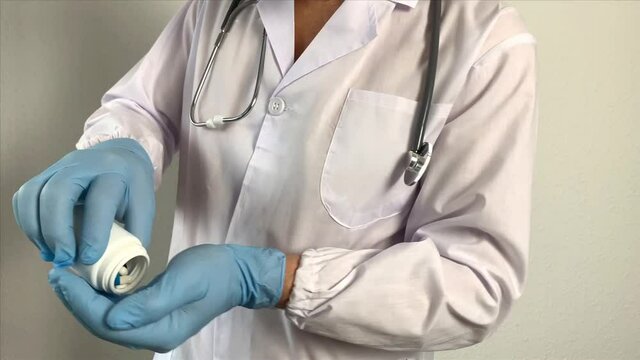 pharmacist, doctor in uniform creates a vaccine, holds pills, pills, new medicine, dietary supplement in his hand, medicine concept, treatment of coronavirus, COVID-19