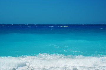 Peaceful sea wave foams on the beach, Aegean Sea, Rhodes, Greece.