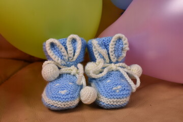Fototapeta na wymiar children's hand-made knitted shoes