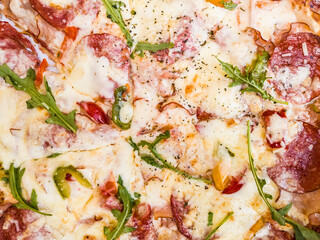 Pizza food Background with Mozzarella cheese, Tomatoes, Pepperoni , Spices and Arugula. Italian pizza.