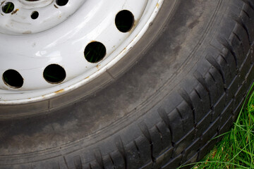 Old car wheel with worn tire