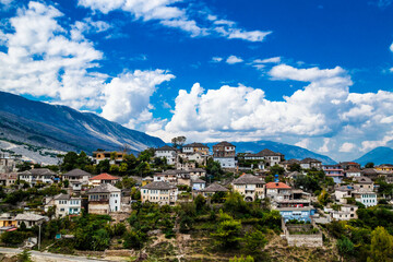 Obraz premium View of Historical UNESCO protected town of Gjirocaster , Southern Albania on background of Balkan mountains. Cloudy dramatic sky.