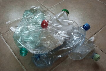 View of a bunch of empty multicolored plastic bottles prepared for recycling. Crumpled clean plastic ready for recycling. Recycling materials. Separate waste collection at home.