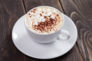 cappuccino with marshmallow on the wooden background