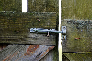 Sliding bolt lock on wooden gate