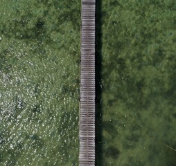 Aerial view of drone photo wooden jetty on a lake. 