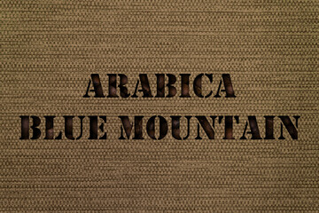 Variety Arabica Blue Mountain text made up of coffee beans on a canvas background