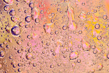 Abstract colorful background with oil drops and waves on water surface