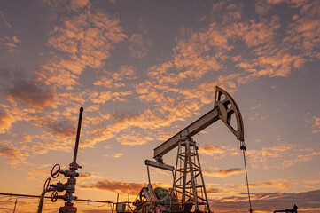 Petroleum concept. Oil pump rig. Oil and gas production. Oilfield site. Pump Jack are running....