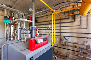 interior of a modern gas boiler room, with a water treatment system, many valves and sensors