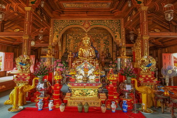 view of Golden Upagupta Buddha Statue on base in buddhist temple, Wat Ming Muang, Chiang Rai, northern of Thailand.