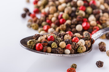 mix of peppercorns on white acrylic background