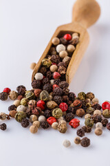 mix of peppercorns on white acrylic background
