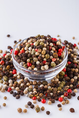 mix of peppercorns on white acrylic background