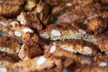 Fresh baked Italian cantucci with almonds on a baking tray.  Tuscan Biscotti. Traditional cantuccini. Homemade Italian sweets biscuits (cookies)