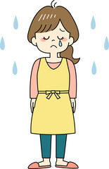 涙を流すエプロン姿の主婦（全身）