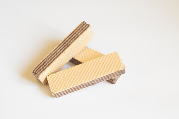 Crispy chocolate wafers. Waffles sticks on the light background. Tasty waffles with space for text. Sweet food