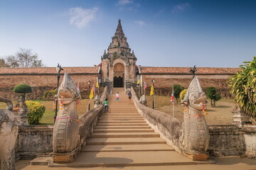 view of Naga (Dragon in chinese) bridge and Wat Phra That Lampang Luang with blue sky background,...