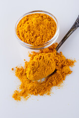 natural turmeric powder on white acrylic background