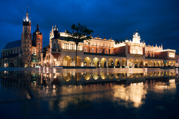 Cloth Hall and St Mary's Church reflected in paddle of water